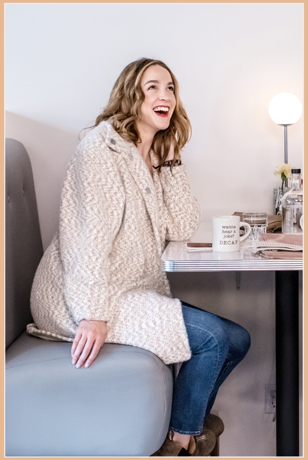Women's Cardigans and Kimonos | Vixen Collection Seattle, WA | Girl siting at a diner booth table wearing a cream knit cardigan