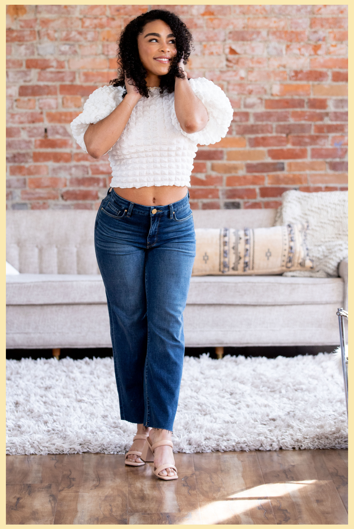 Denim Collection | Brunette woman wearing denim jeans a white short sleeve top 