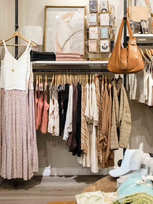 Clothing rack with various garments in a store setting