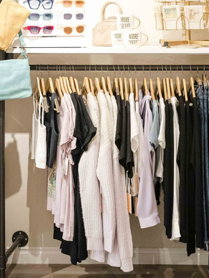 Clothing rack with shirts and pants in a store setting